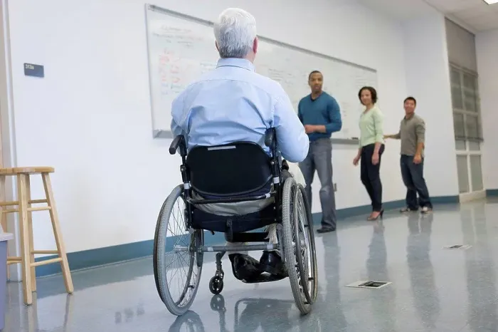 Framed Print : University professor with Muscular Dystrophy with his students in a classroom Framed Print : University professor with Muscular Dystrophy with his students in a classroom