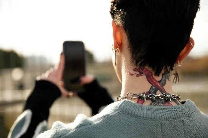 Framed Print : Unrecognizable girl with a tattoo taking a picture Framed Print : Unrecognizable girl with a tattoo taking a picture