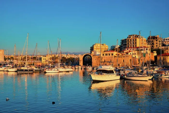 Framed Print : Venetian Fort castle in Heraklion and moored fishing boats, Crete Island, Greece on sunset