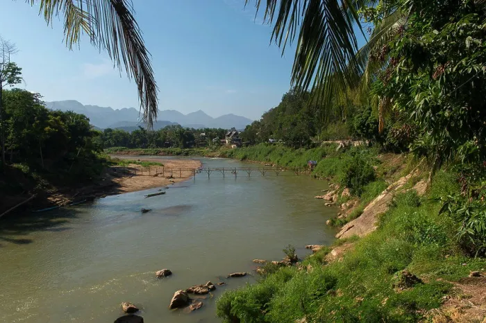 Framed Print : View of a bamboo bridge over the Nam Khan River in Luang Prabang in Central Laos Framed Print : View of a bamboo bridge over the Nam Khan River in Luang Prabang in Central Laos