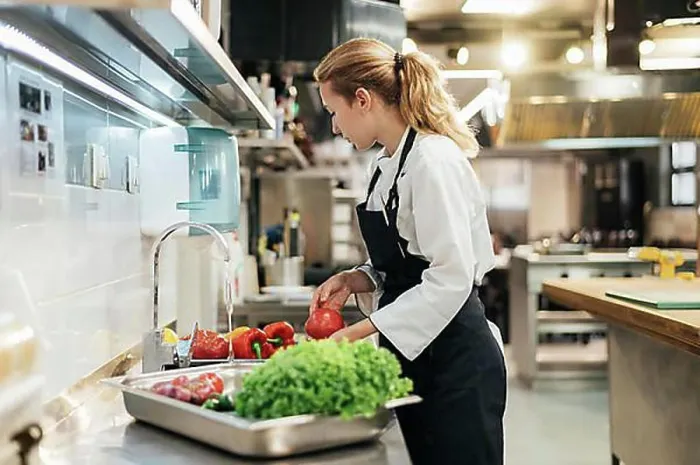 Framed Print : Side view female chef washing vegetables kitchen Framed Print : Side view female chef washing vegetables kitchen
