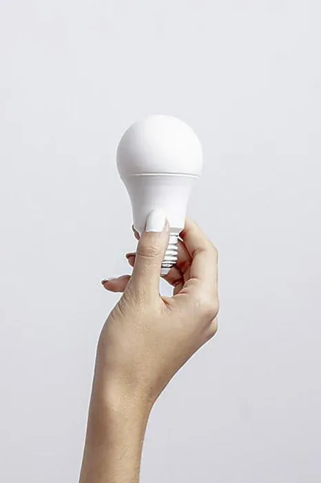 Framed Print : Front view hand holding light bulb with copy space