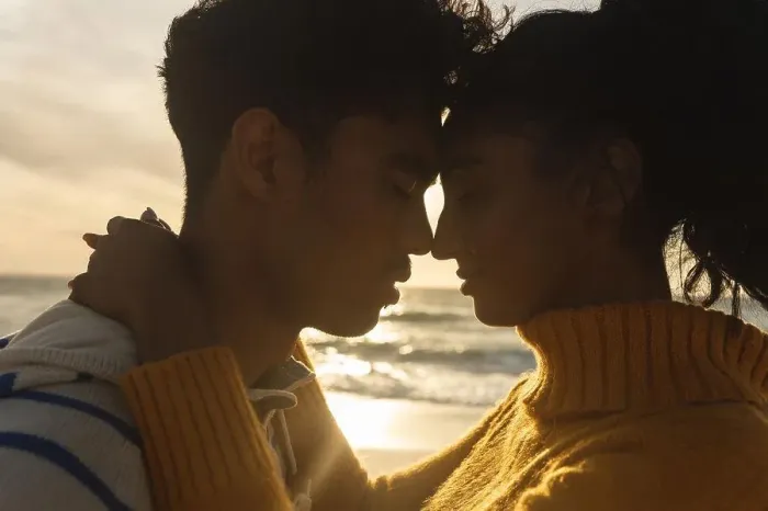 Framed Print : Side view of multiracial couple romancing while hugging each other at beach during sunset. lifestyle, love and weekend Framed Print : Side view of multiracial couple romancing while hugging each other at beach during sunset. lifestyle, love and weekend