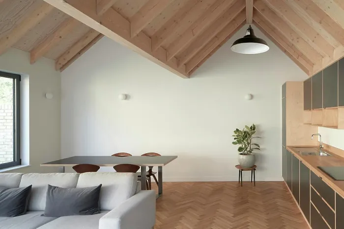 Framed Print : A view of the open plan living room / kitchen with vaulted ceiling and soft furnishings