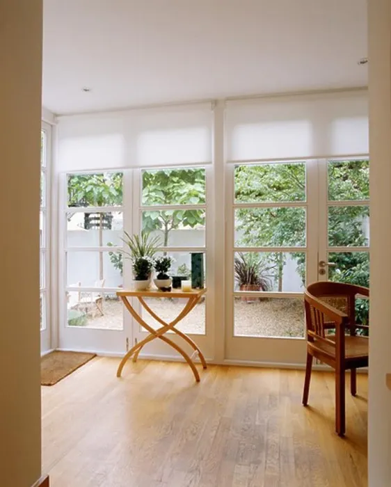 Framed Print : View of patio through glass doors with white blinds in modern livingroom with small table on wooden floor Framed Print : View of patio through glass doors with white blinds in modern livingroom with small table on wooden floor