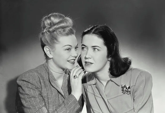 Framed Print : Vintage photograph. Blonde woman telling secret to brunette woman sitting next to her Framed Print : Vintage photograph. Blonde woman telling secret to brunette woman sitting next to her