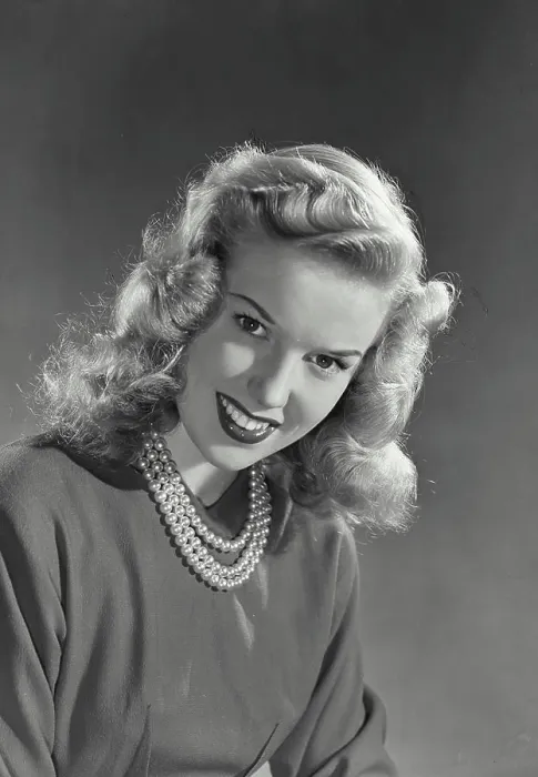 Framed Print : Vintage photograph. Blonde woman with wavy hair wearing blouse and pearl necklace smiling Framed Print : Vintage photograph. Blonde woman with wavy hair wearing blouse and pearl necklace smiling