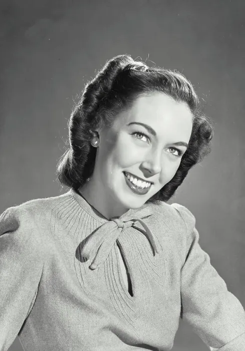 Framed Print : Vintage photograph. Brunette woman wearing sweater blouse with tie on collar smiling looking up