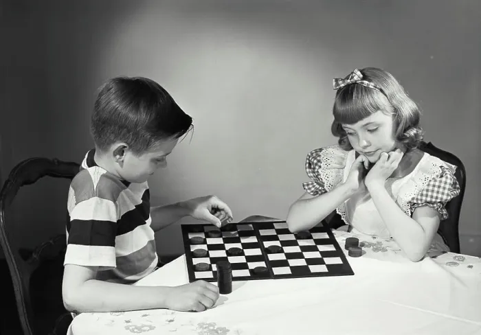 Framed Print : Vintage photograph. Children at table playing checkers Framed Print : Vintage photograph. Children at table playing checkers