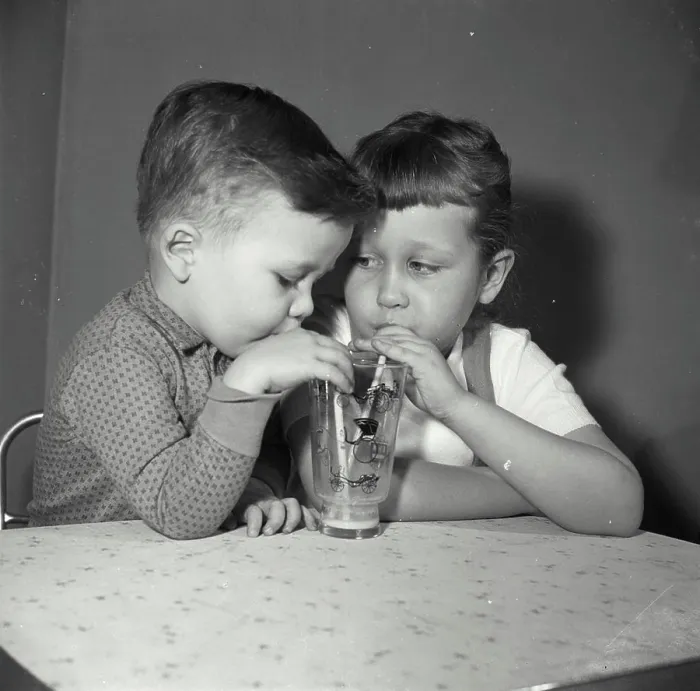 Framed Print : Vintage Photograph. Close-up of a boy and his sister sharing a glass of juice Framed Print : Vintage Photograph. Close-up of a boy and his sister sharing a glass of juice