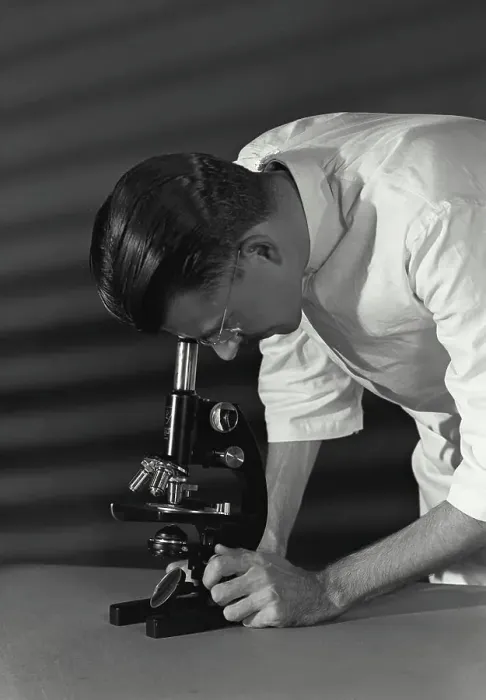 Framed Print : Vintage Photograph. Close-up of a scientist looking through a microscope Framed Print : Vintage Photograph. Close-up of a scientist looking through a microscope