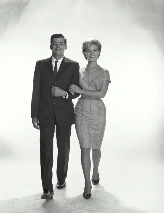 Framed Print : Vintage Photograph. A couple with linked arms walking and smiling in studio Framed Print : Vintage Photograph. A couple with linked arms walking and smiling in studio