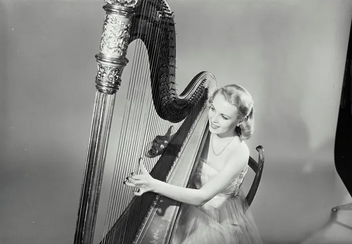 Framed Print : Vintage Photograph. Diane Williams. Model Released. Woman in dress smiling and playing Grand Pedal Harp. Frame 5