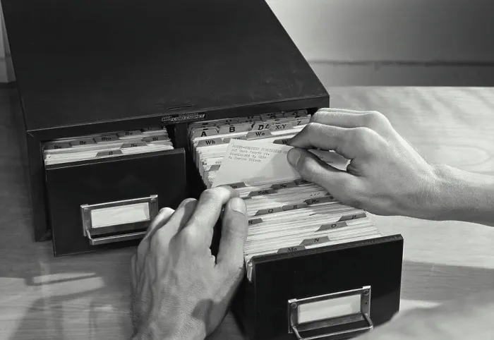 Framed Print : Vintage photograph. High angle view of a businessman filing cards in drawer Framed Print : Vintage photograph. High angle view of a businessman filing cards in drawer