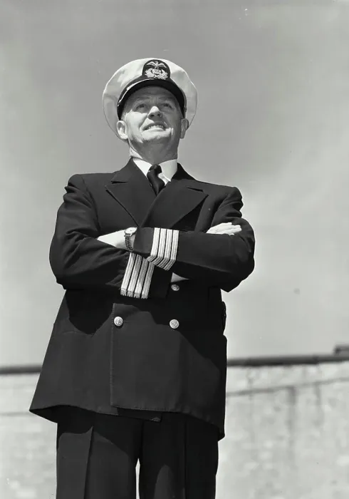 Framed Print : Vintage Photograph. Man in captains uniform standing with arms crossed and smiling Framed Print : Vintage Photograph. Man in captains uniform standing with arms crossed and smiling