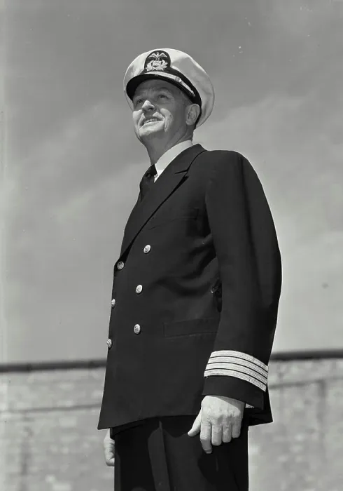 Framed Print : Vintage Photograph. Man in captains uniform standing and looking off camera and smiling Framed Print : Vintage Photograph. Man in captains uniform standing and looking off camera and smiling