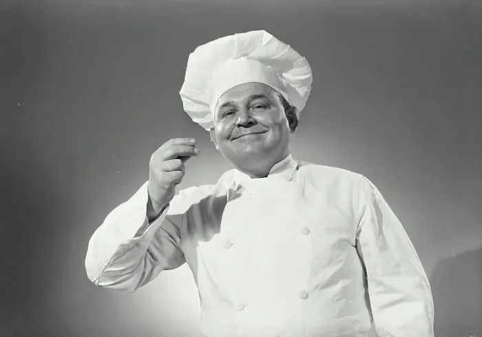Framed Print : Vintage Photograph. Man in chefs uniform tasting an imaginary spoon