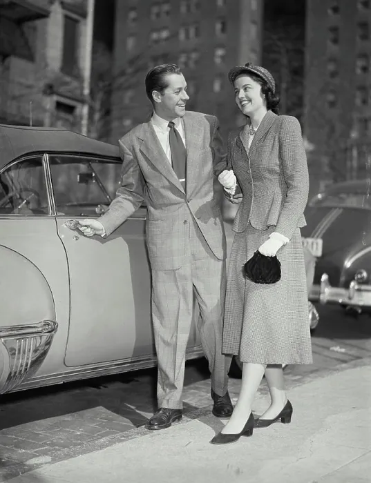 Framed Print : Vintage photograph. Man opening car door for his date Framed Print : Vintage photograph. Man opening car door for his date