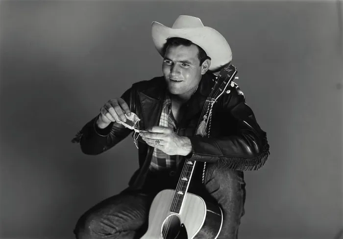 Framed Print : Vintage Photograph. Man sits with guitar as he rolls up a ciggarette Framed Print : Vintage Photograph. Man sits with guitar as he rolls up a ciggarette
