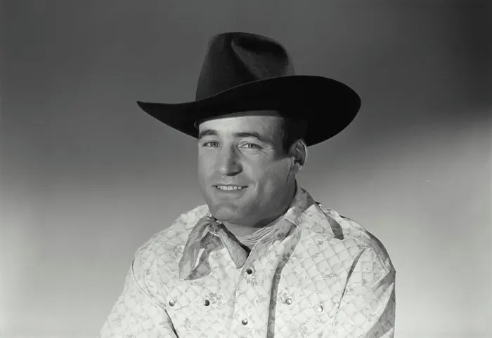 Framed Print : Vintage Photograph. Man sits for studio portrait smiling in black cowboy hat and bandana