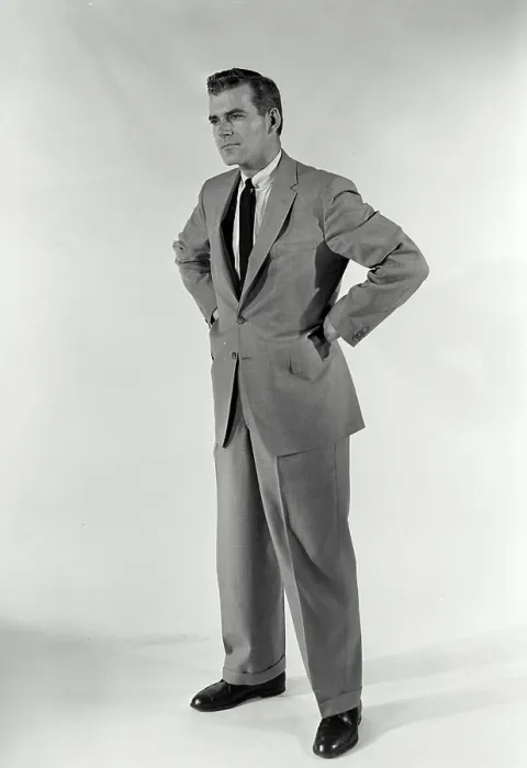 Framed Print : Vintage Photograph. A man standing with hands on his hips with a stern expression