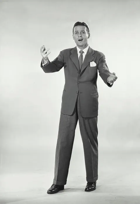 Framed Print : Vintage photograph. Man in suit standing with arms raised Framed Print : Vintage photograph. Man in suit standing with arms raised