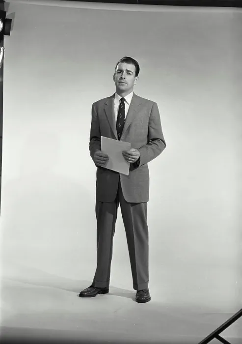 Framed Print : Vintage Photograph. Man in suit and tie holding sheet of paper on white background. Frame 1