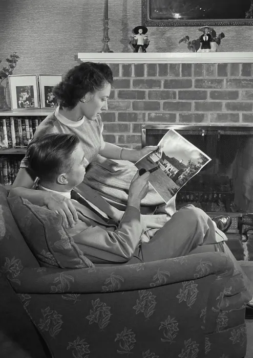 Framed Print : Vintage Photograph. Man and Wife sitting in chair and looking at picture. Frame 4 Framed Print : Vintage Photograph. Man and Wife sitting in chair and looking at picture. Frame 4