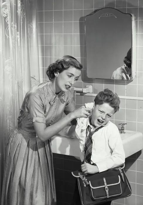 Framed Print : Vintage photograph. Mother cleaning unhappy young boys ear