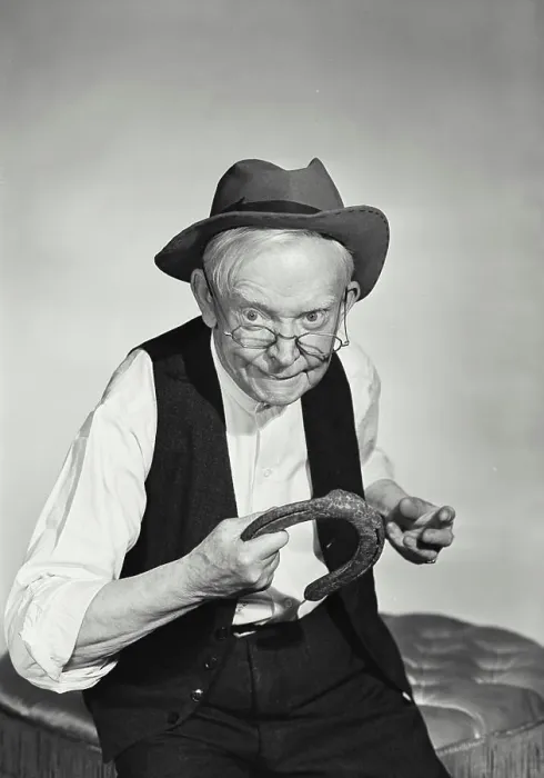 Framed Print : Vintage Photograph. Old man with glasses wearing hat and wool vest about to throw horseshoe Framed Print : Vintage Photograph. Old man with glasses wearing hat and wool vest about to throw horseshoe