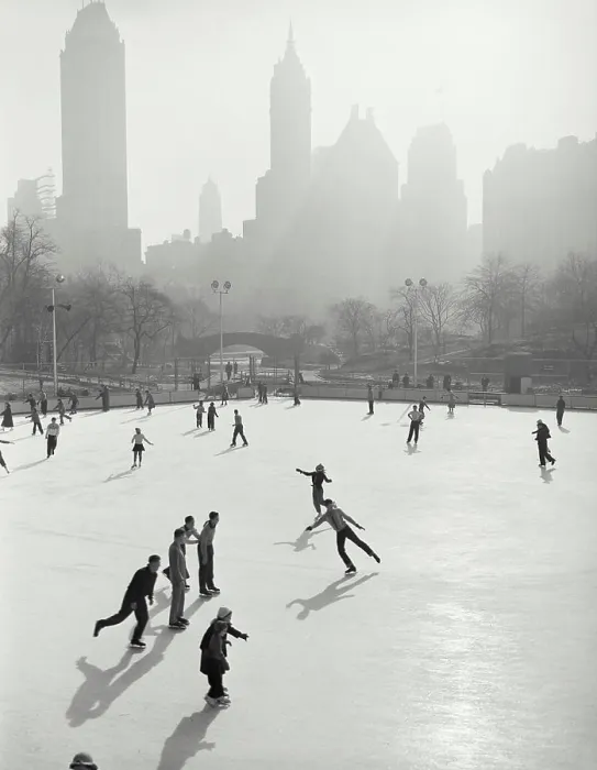 Framed Print : Vintage photograph. People skating at Wollman Memorial Ice Rink in Central Park with hazy buildings in background