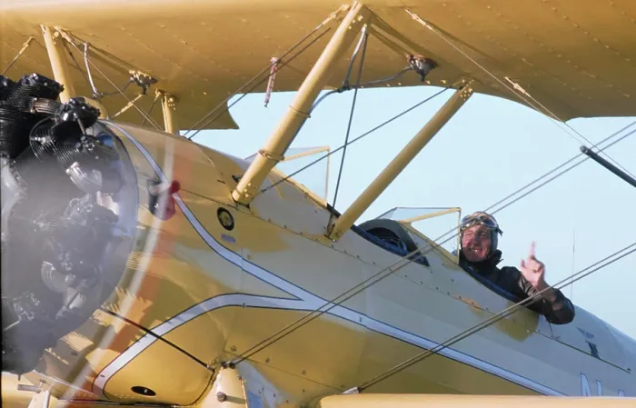 Framed Print : Vintage Photograph. Pilot in vintage biplane gives thumbs up for a thrilling open-air flight experience