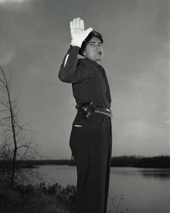 Framed Print : Vintage photograph. Policeman blowing whistle while holding up hand Framed Print : Vintage photograph. Policeman blowing whistle while holding up hand