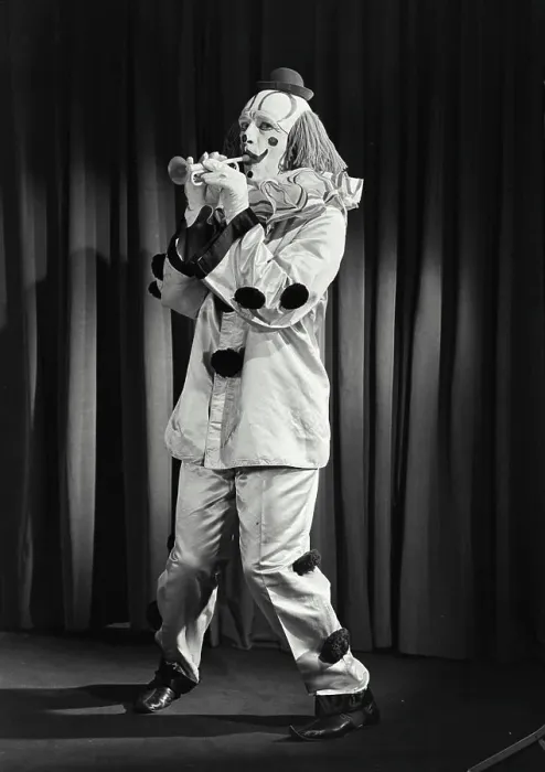 Framed Print : Vintage photograph. Portrait of clown wearing silly hat and playing toy horn