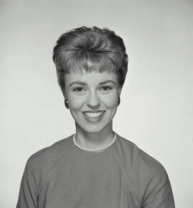 Framed Print : Vintage Photograph. A portrait of a woman with a big smile wearing a pearl necklace with short hairstyle