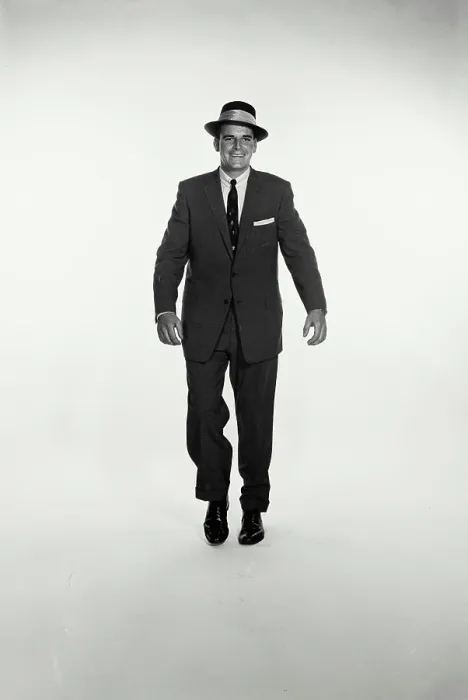 Framed Print : Vintage Photograph. A studio shot of a man in a dark suit walking towards the camera. Frame 3