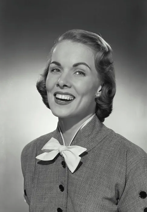 Framed Print : Vintage photograph. Woman in button blouse with bow smiling at camera Framed Print : Vintage photograph. Woman in button blouse with bow smiling at camera
