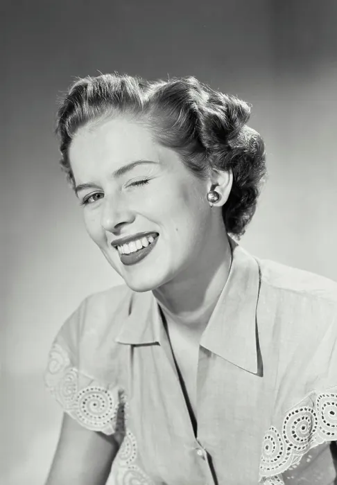 Framed Print : Vintage photograph. Woman in collared blouse winking at camera