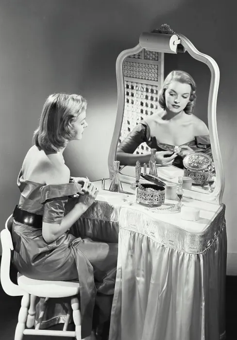Framed Print : Vintage photograph. woman getting ready at vanity