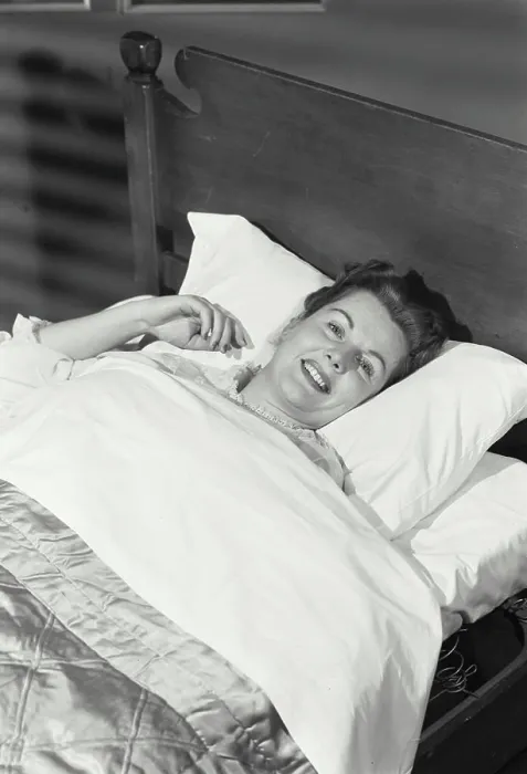 Framed Print : Vintage Photograph. Woman lying in bed smiling Framed Print : Vintage Photograph. Woman lying in bed smiling