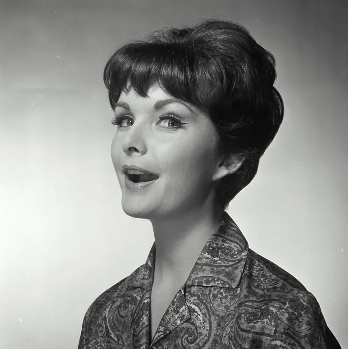 Framed Print : Vintage Photograph. A woman with her mouth open facing to the left of frame looking at the camera