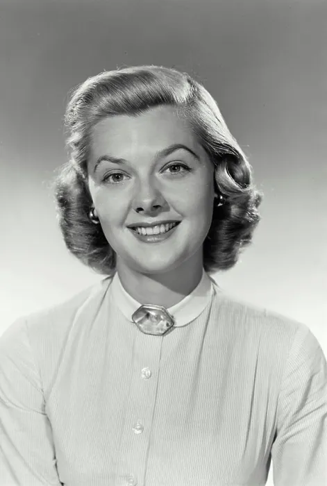 Framed Print : Vintage Photograph. Woman sits smiling for studio portrait with a white shirt on with a jewel at the top Framed Print : Vintage Photograph. Woman sits smiling for studio portrait with a white shirt on with a jewel at the top