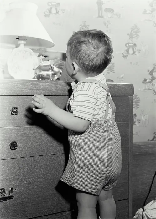 Framed Print : Vintage Photograph. Young boy placing coin in piggy bank Framed Print : Vintage Photograph. Young boy placing coin in piggy bank