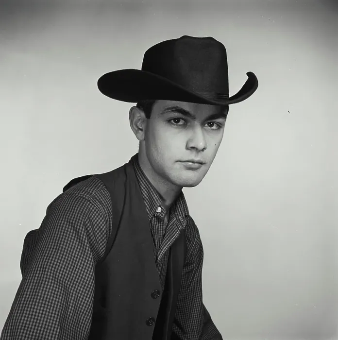 Framed Print : Vintage Photograph. Young man poses for studio portrait wearing cowboy hat and vest Framed Print : Vintage Photograph. Young man poses for studio portrait wearing cowboy hat and vest