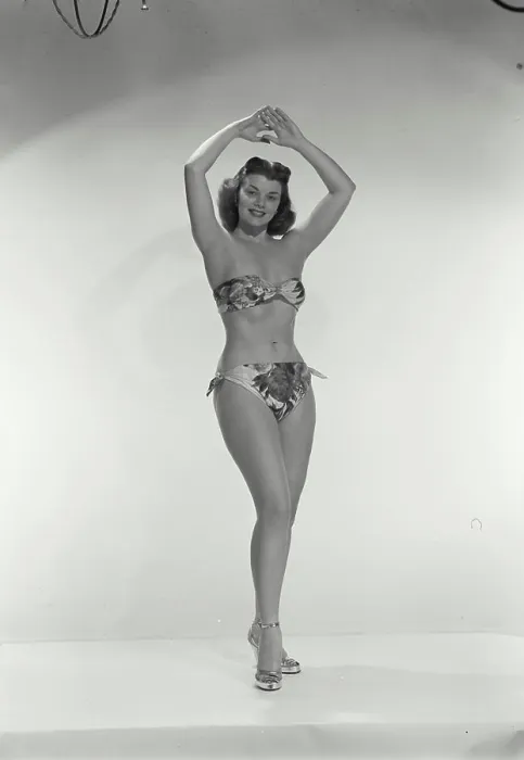 Framed Print : Vintage Photograph. Young woman in bikini with arms above head