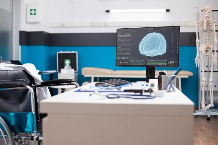 Framed Print : Wheelchair user doctors table with desktop pc showing brain imaging in vacant clinic room Framed Print : Wheelchair user doctors table with desktop pc showing brain imaging in vacant clinic room