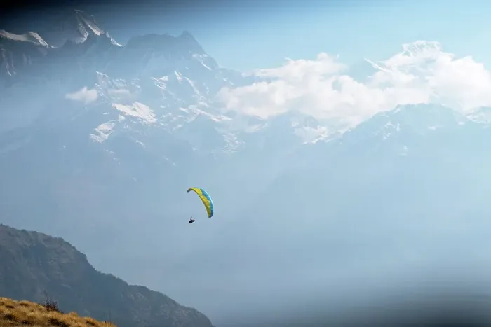 Framed Print : Wide shot of a paraglider in Nepal with mountain range in background