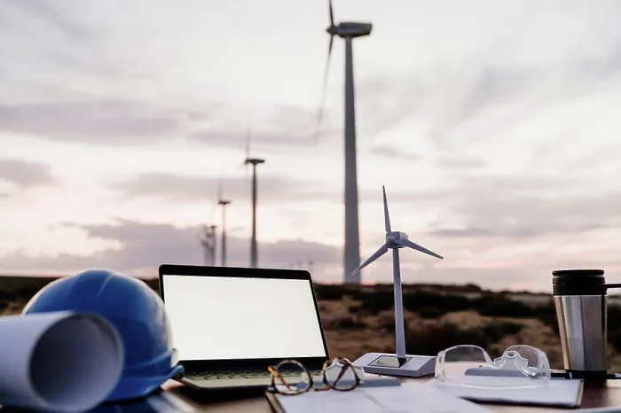 Framed Print : Wind turbine model by laptop with blank screen on desk at wind farm Framed Print : Wind turbine model by laptop with blank screen on desk at wind farm