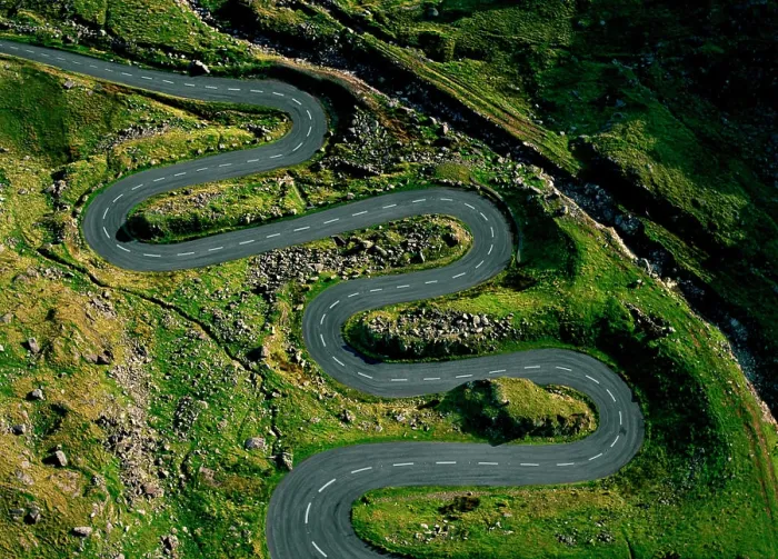 Framed Print : A winding road snakes through a lush green hillside Framed Print : A winding road snakes through a lush green hillside
