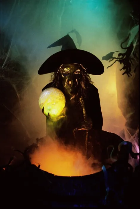 Framed Print : Witch holding a crystal ball standing in front of a cauldron Framed Print : Witch holding a crystal ball standing in front of a cauldron